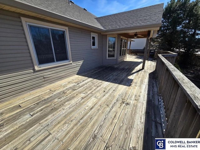 wooden terrace with a ceiling fan