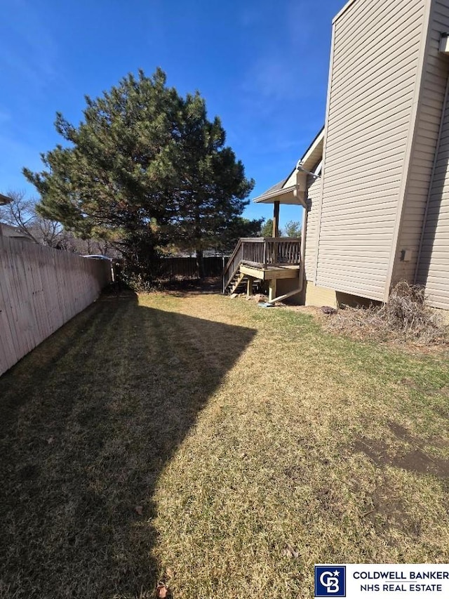 view of yard with a deck and a fenced backyard