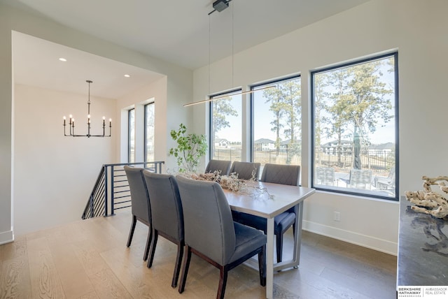 dining room with recessed lighting, baseboards, an inviting chandelier, and wood finished floors