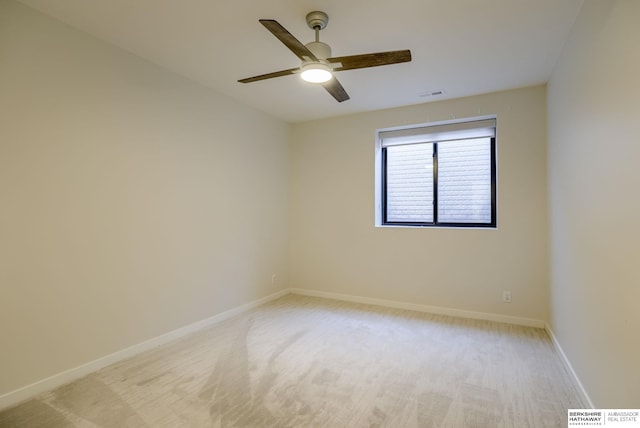 spare room featuring a ceiling fan, baseboards, visible vents, and light carpet