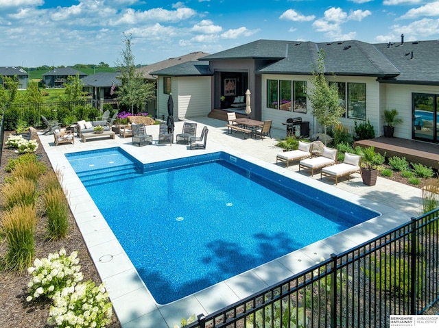 view of swimming pool featuring a fenced in pool, an outdoor living space, a patio, and fence