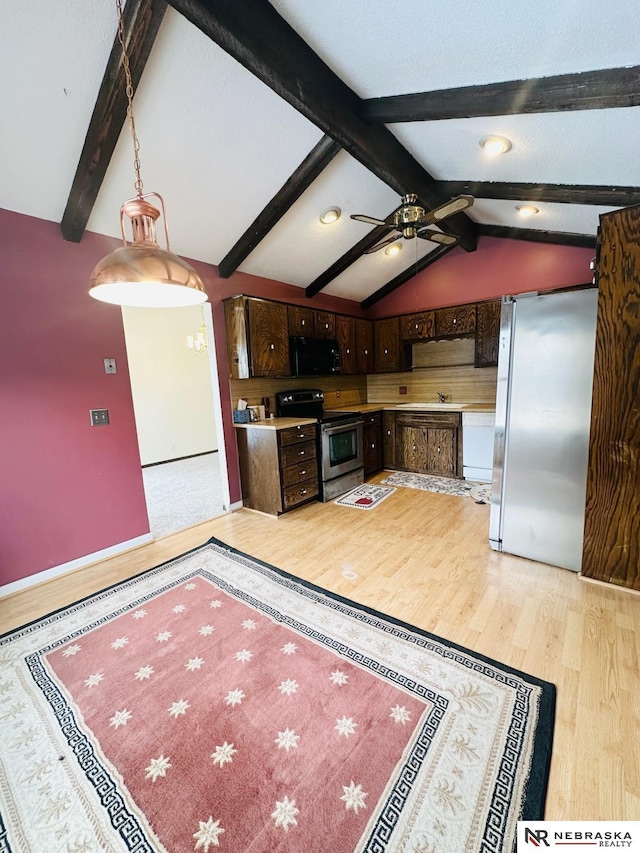 kitchen with ceiling fan, dark brown cabinetry, lofted ceiling with beams, light wood-style floors, and stainless steel appliances