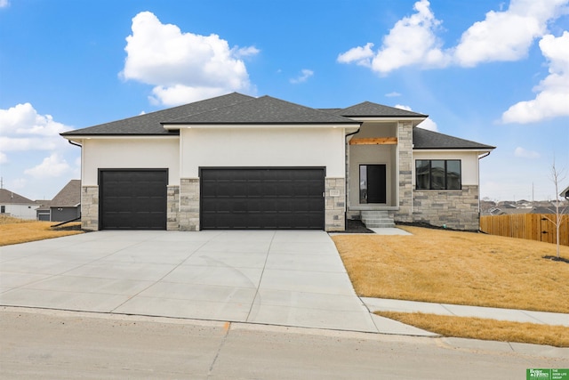 prairie-style house featuring stone siding, stucco siding, driveway, and a garage