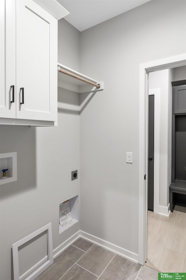 laundry area featuring cabinet space, electric dryer hookup, hookup for a washing machine, and baseboards