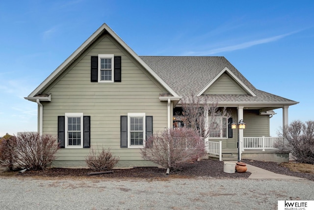 view of front of home featuring covered porch and roof with shingles