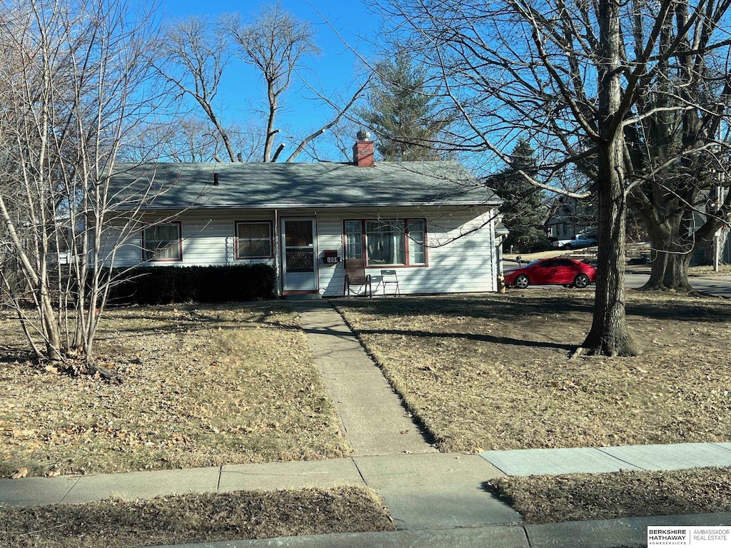 single story home with a chimney