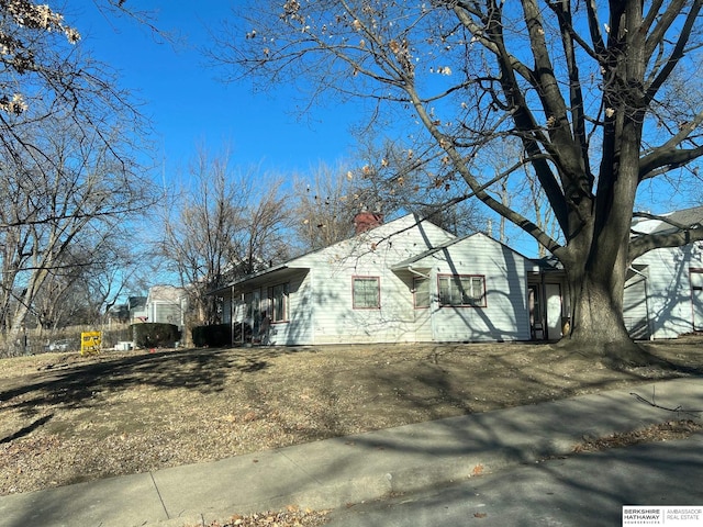 view of side of home featuring a chimney