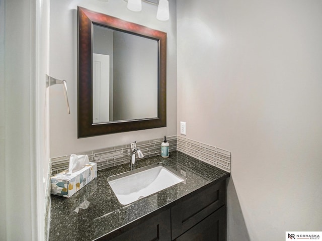 bathroom featuring decorative backsplash and vanity