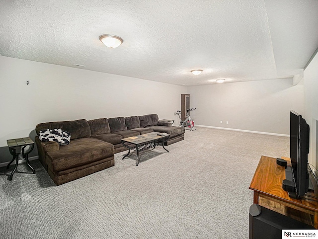 living area with carpet, baseboards, and a textured ceiling