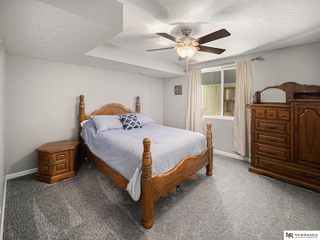 bedroom featuring a textured ceiling, baseboards, carpet, and a ceiling fan