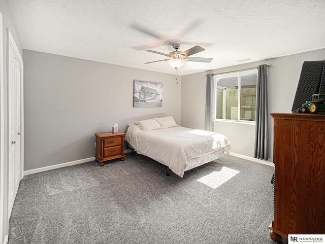 carpeted bedroom featuring ceiling fan, baseboards, and a textured ceiling