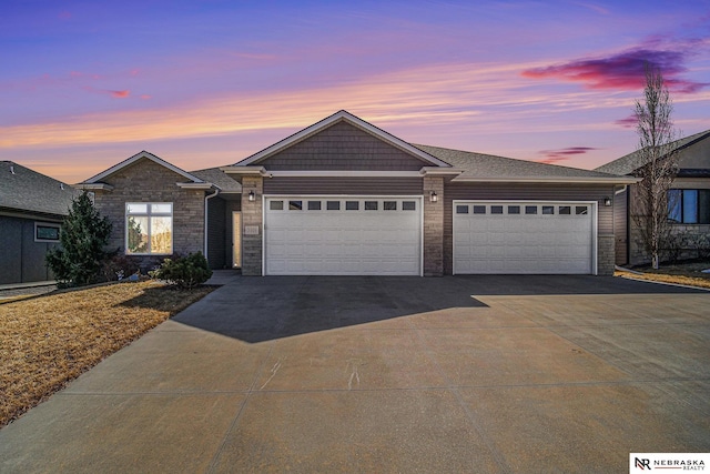 view of front of home with concrete driveway and a garage