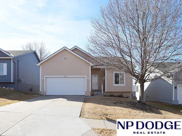 ranch-style house featuring an attached garage and driveway