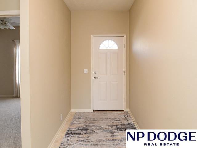 doorway featuring baseboards