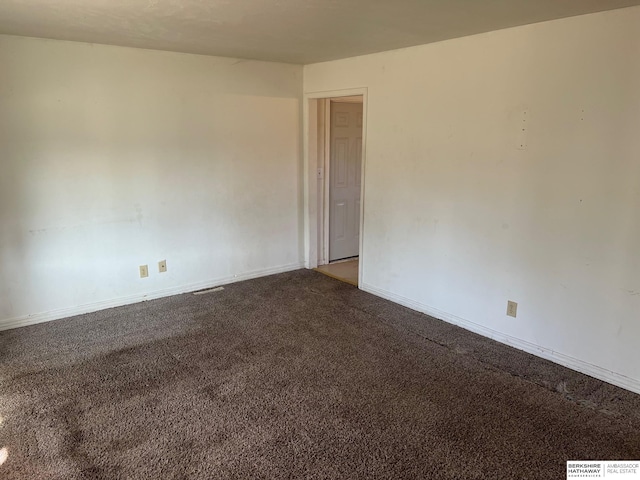 carpeted spare room with baseboards