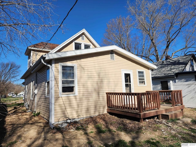 back of property with a wooden deck