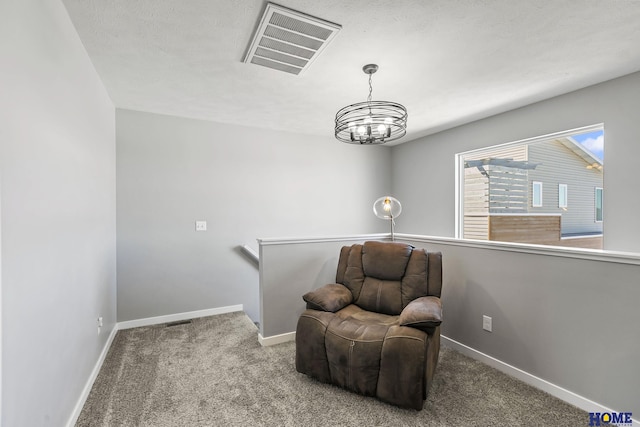 living area featuring an inviting chandelier, carpet flooring, baseboards, and visible vents