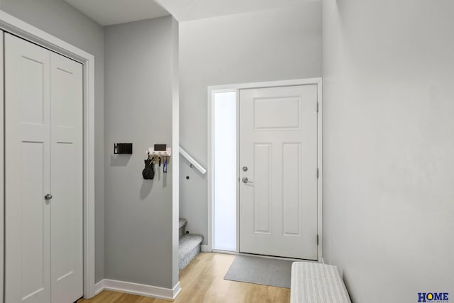 interior space with baseboards and light wood-style floors