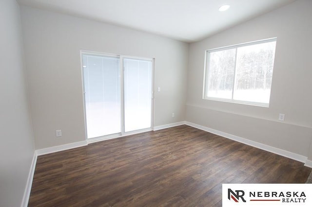 empty room with recessed lighting, baseboards, dark wood-type flooring, and lofted ceiling