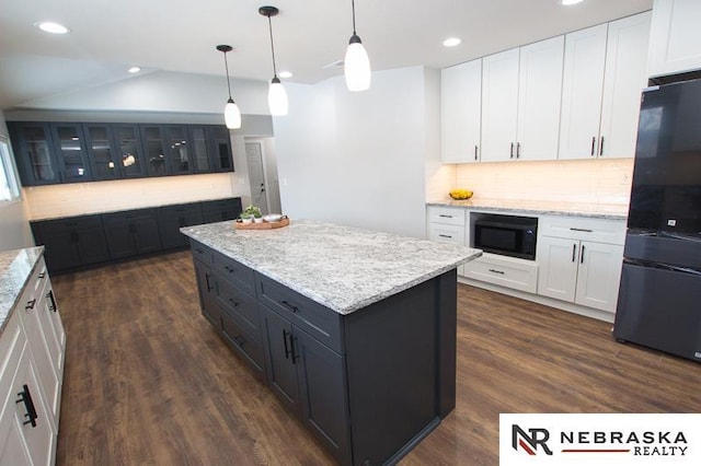 kitchen with black appliances, dark wood-style floors, a center island, and white cabinetry