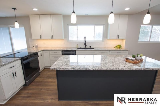 kitchen with black appliances, decorative backsplash, dark wood-style floors, white cabinetry, and a sink