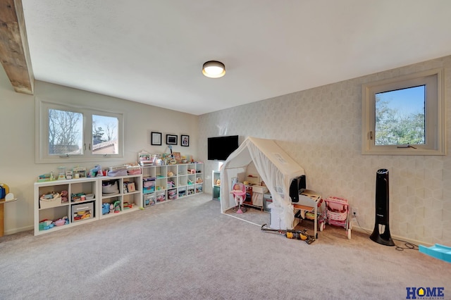 playroom with wallpapered walls, carpet flooring, and a wealth of natural light