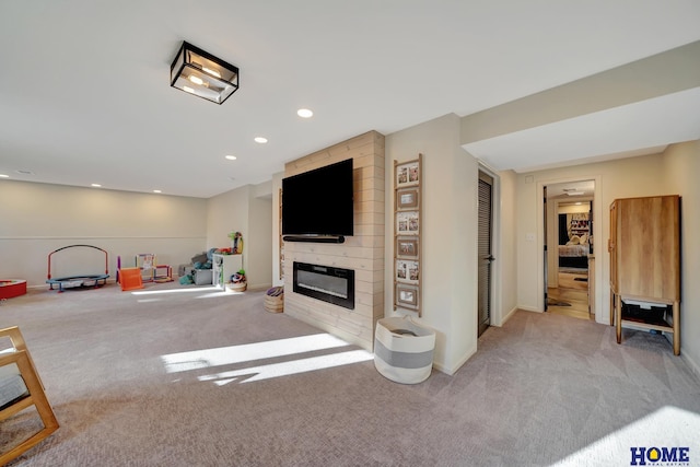 game room featuring recessed lighting, baseboards, carpet floors, and a large fireplace