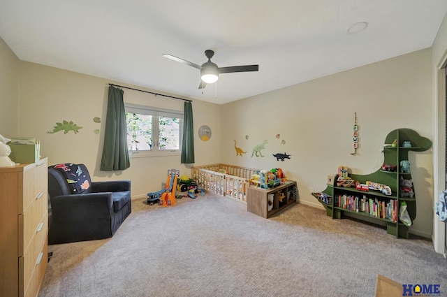 recreation room with carpet flooring, baseboards, and ceiling fan