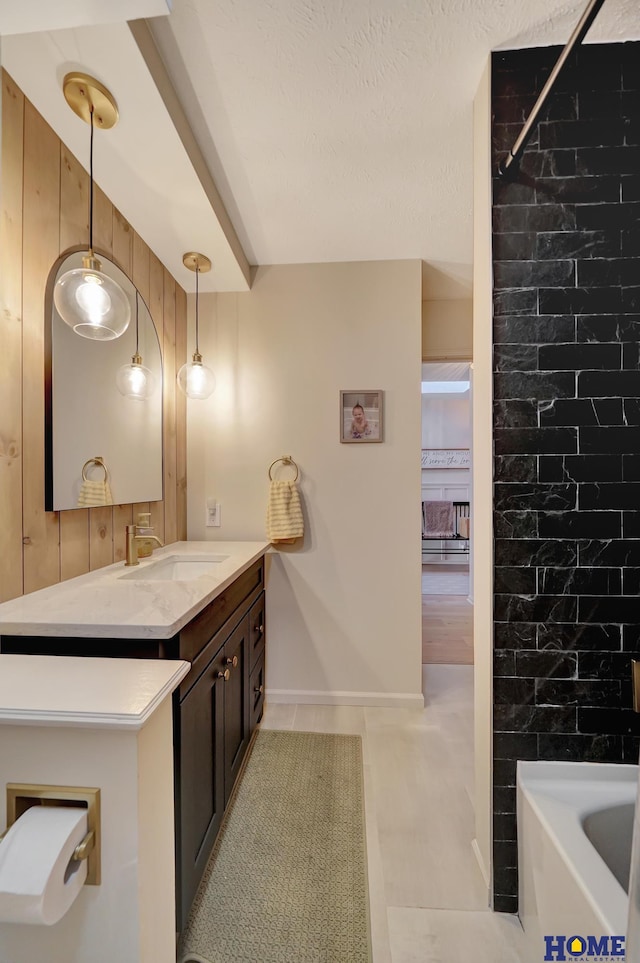 bathroom featuring a bath, wooden walls, vanity, and walk in shower