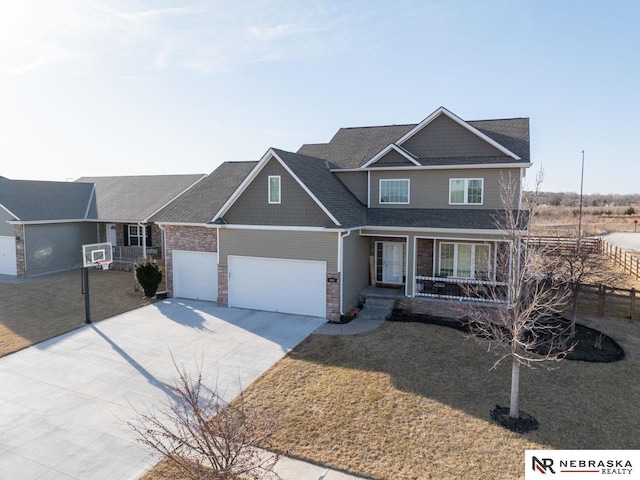 craftsman-style home featuring covered porch, concrete driveway, and a front yard