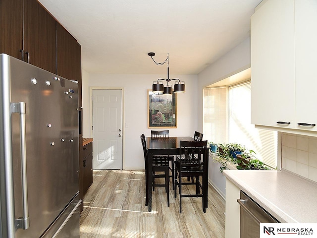 dining area featuring light wood-type flooring