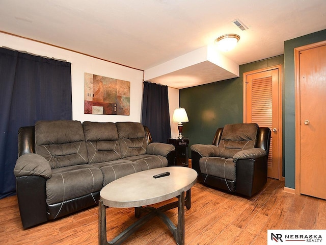 living room featuring light wood finished floors and visible vents