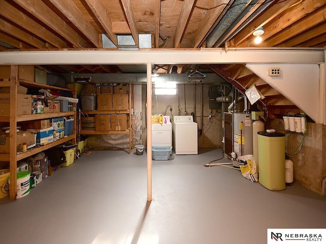 unfinished below grade area featuring gas water heater and separate washer and dryer