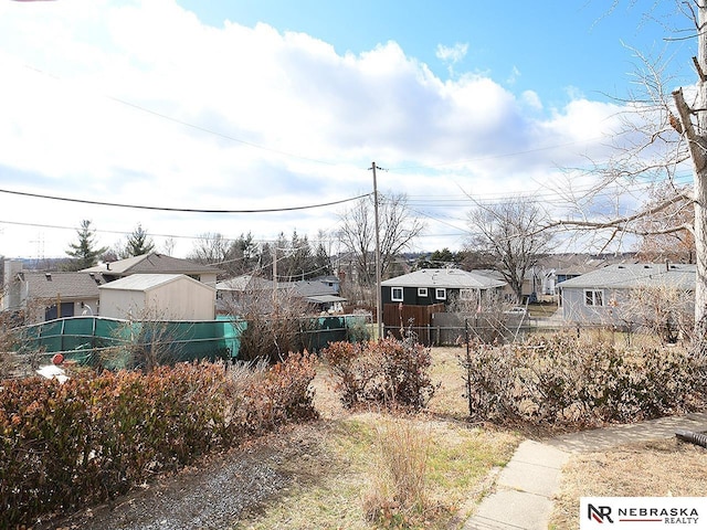 view of yard featuring a residential view and fence