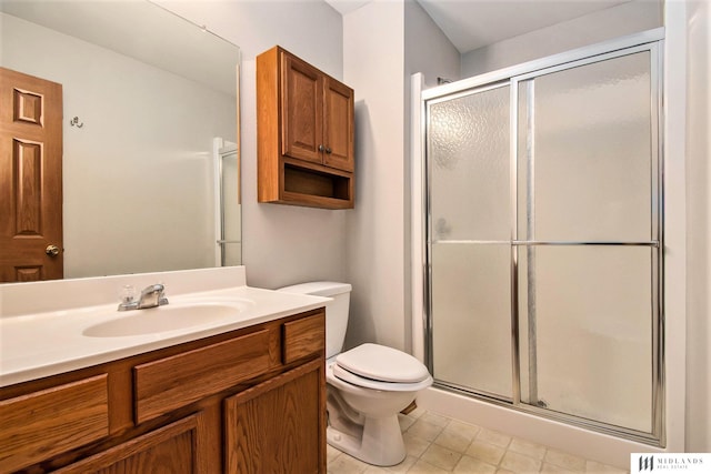 bathroom with a shower stall, toilet, and vanity