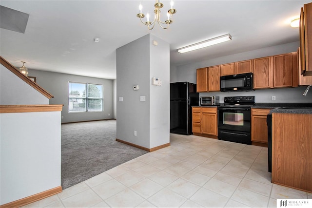 kitchen featuring dark countertops, a chandelier, open floor plan, light colored carpet, and black appliances