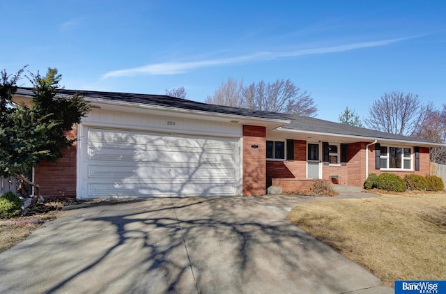 ranch-style house with concrete driveway, an attached garage, and brick siding