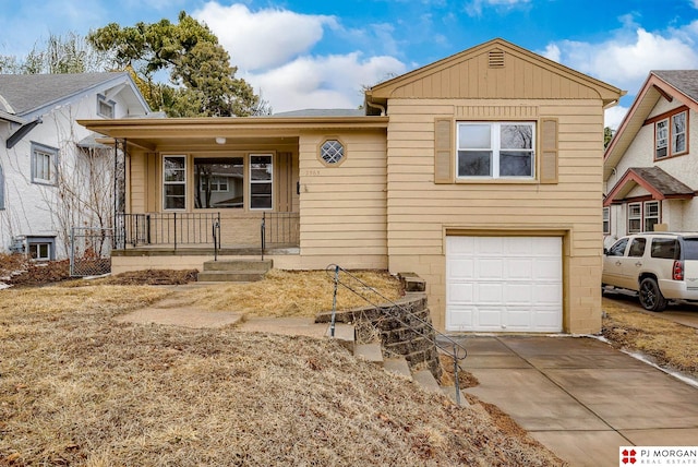 view of front of home with covered porch, driveway, and a garage