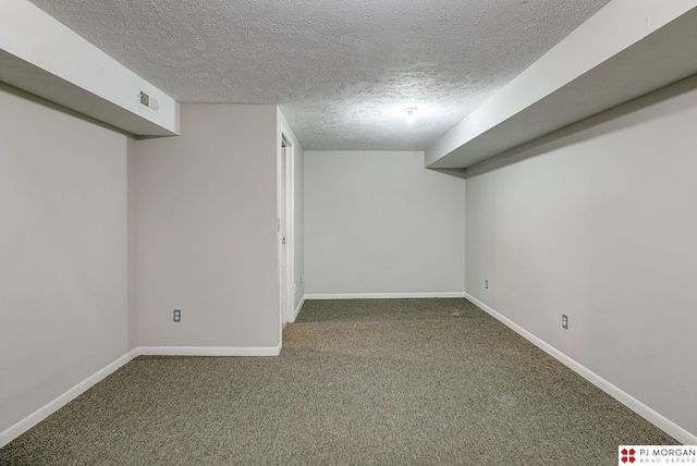 finished basement with visible vents, carpet floors, and baseboards