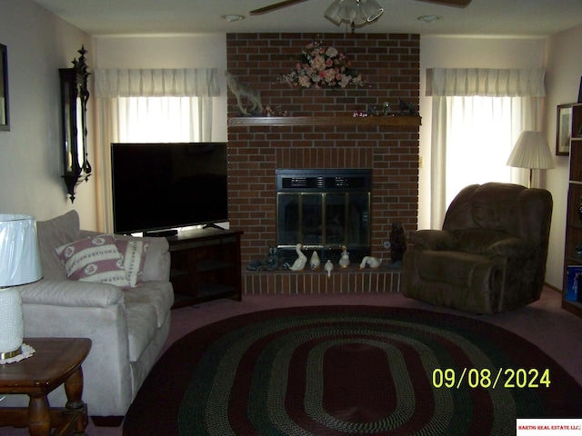 living room featuring plenty of natural light, carpet flooring, and a fireplace