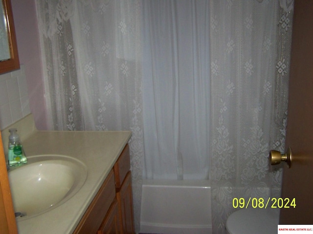 full bathroom featuring vanity, toilet, and shower / bathtub combination with curtain