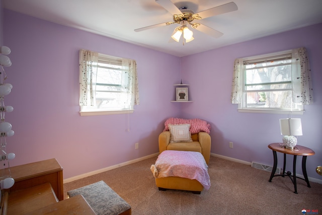 sitting room with carpet flooring, baseboards, and ceiling fan