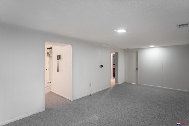 carpeted empty room featuring visible vents