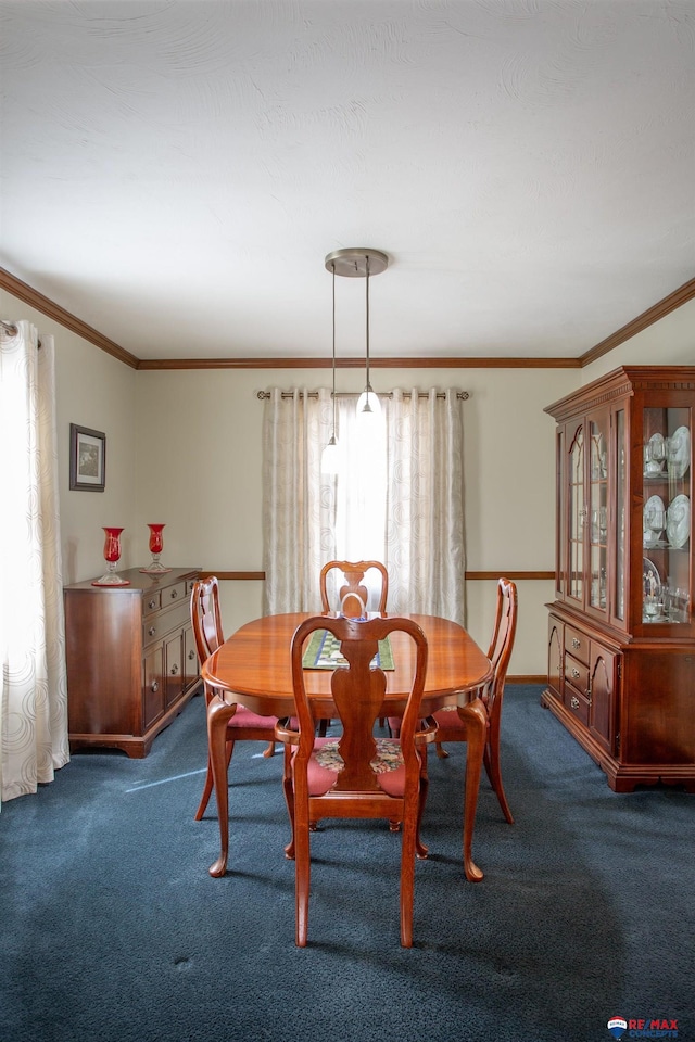 dining room featuring dark colored carpet and crown molding