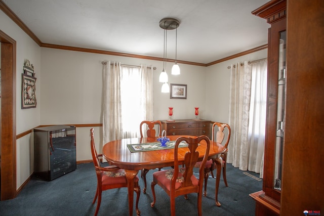 carpeted dining area with baseboards and ornamental molding