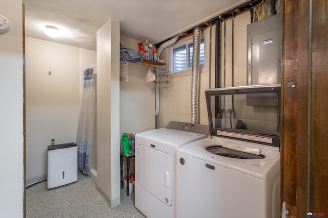 washroom with washer and dryer, laundry area, and concrete block wall