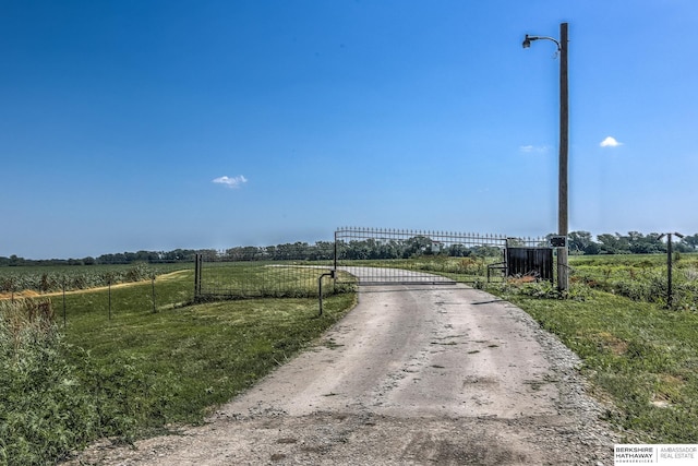 view of street featuring a gated entry, a rural view, and a gate