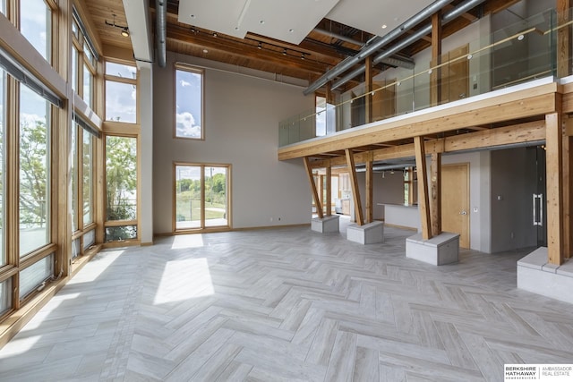 interior space with a high ceiling and baseboards