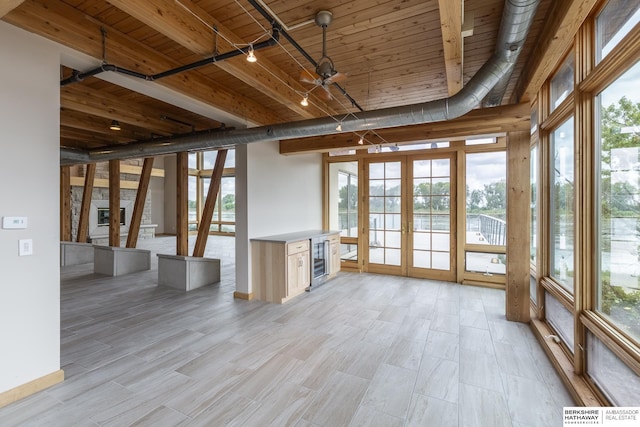 interior space featuring wooden ceiling, french doors, rail lighting, and a healthy amount of sunlight