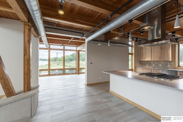 kitchen with a wealth of natural light, baseboards, tasteful backsplash, and appliances with stainless steel finishes